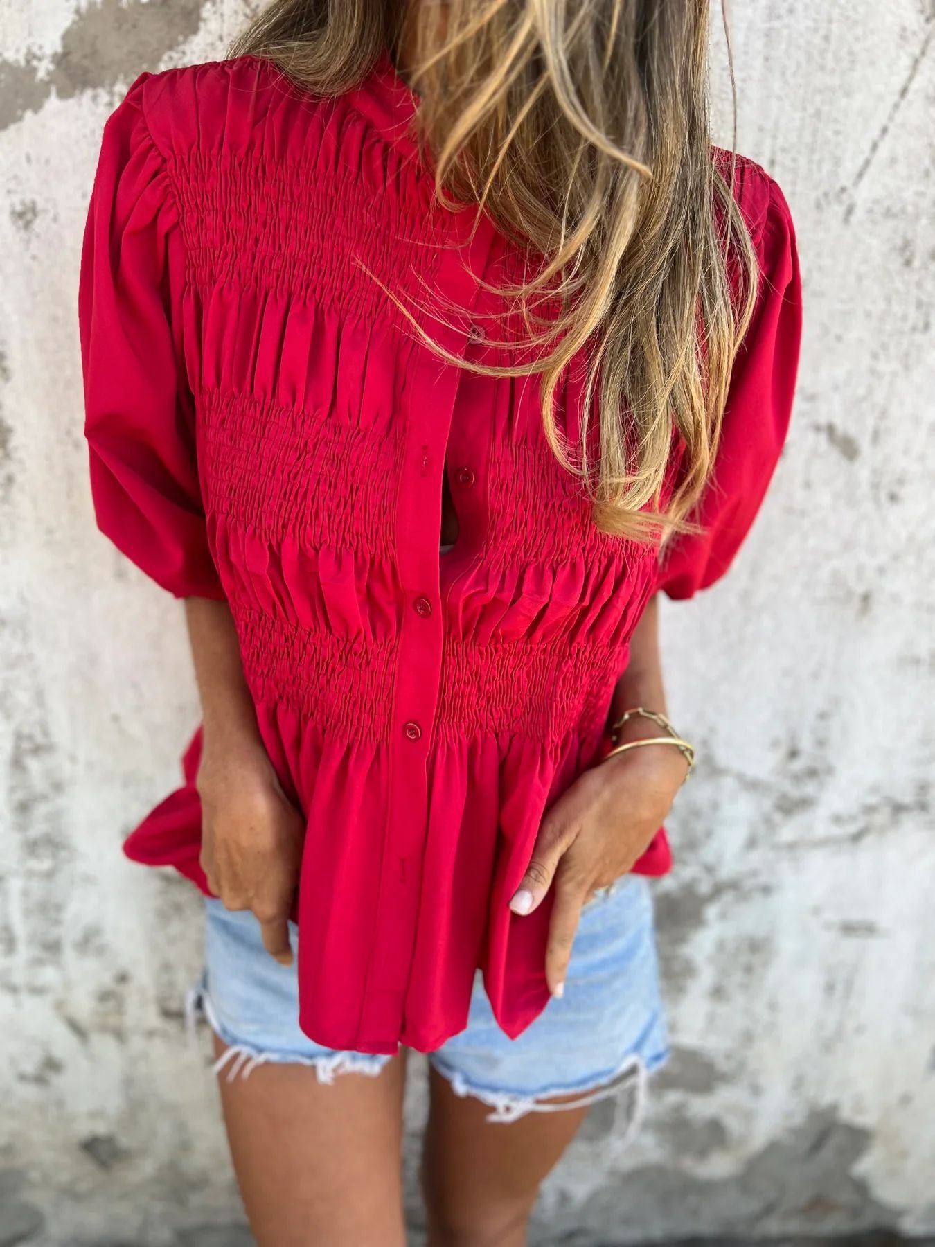Women's pleated shirt with a round neckline and buttons