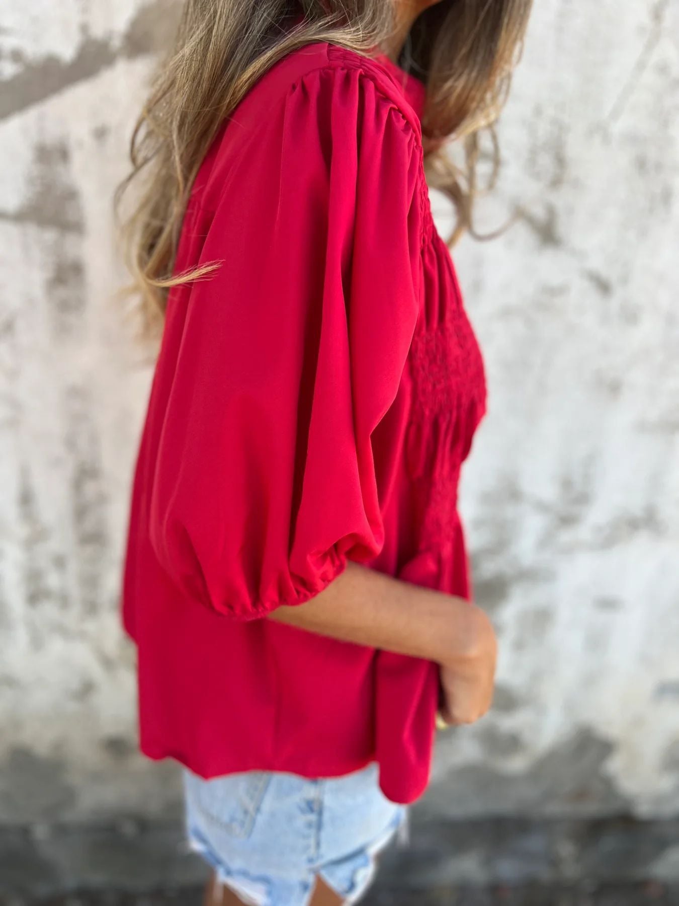 Women's pleated shirt with a round neckline and buttons