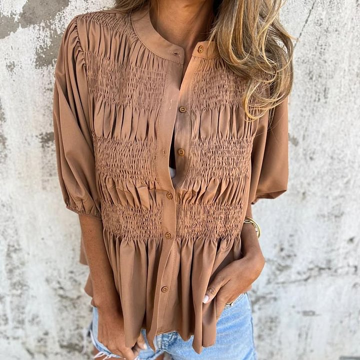 Women's pleated shirt with a round neckline and buttons